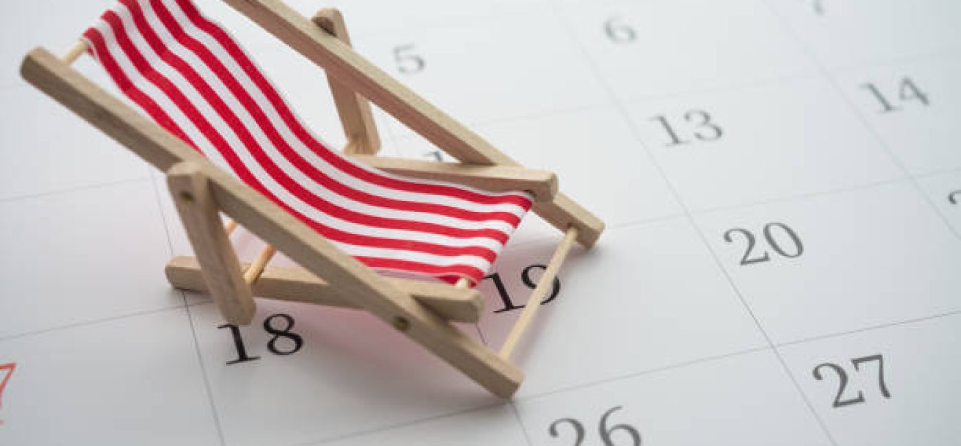 Red beach chair on white blank calendar background copy space. Annual leave travel period for relaxation concept. Period of paid time off (PTO) granted to employees by their employer.